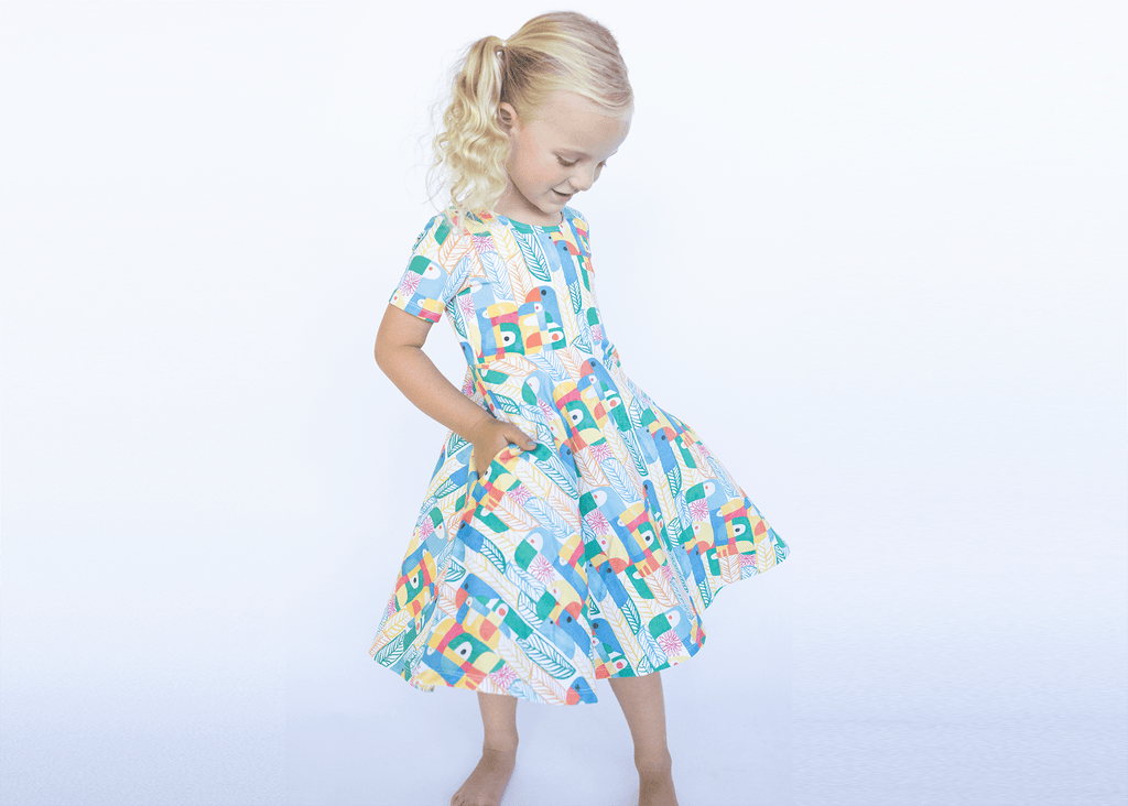 Anise & Ava genderless hand drawn exclusive art, eco friendly printed on premium cotton. Anise & Ava's parrot print pocket dress is made to match baby styles as well as siblings button down shirts. 