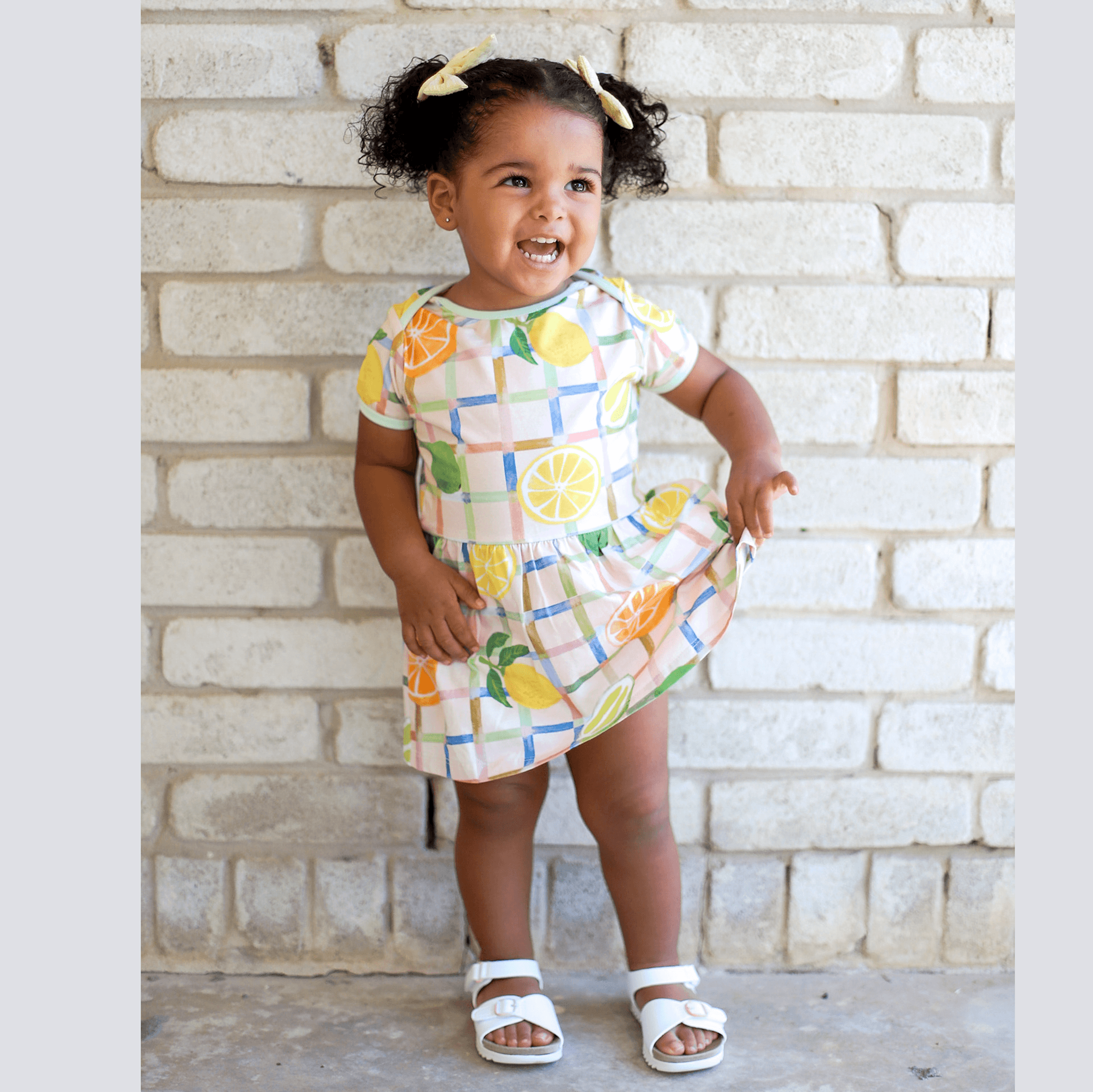 Anise & Ava exclusive hand drawn print in Citrus, eco friendly printed on a stretch luxury cotton for baby. Designed and made to match siblings styles in kids.