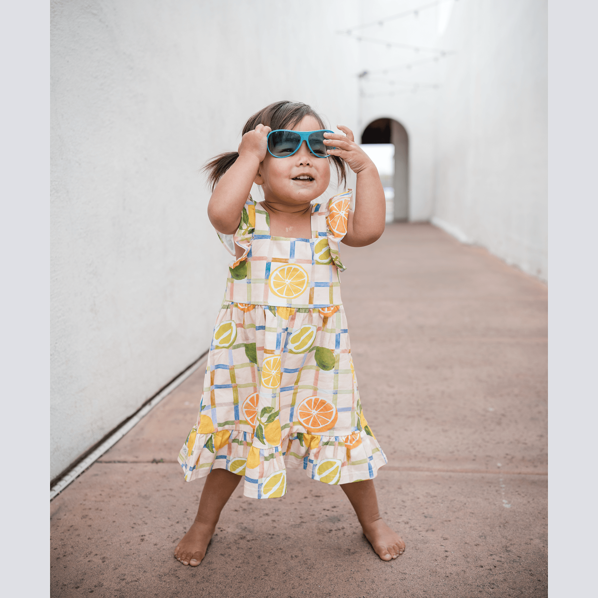 Anise & Ava exclusive hand drawn genderless Citrus print eco friendly printed on luxury stretch cotton. Designed and made to match siblings styles. Our new sleeveless Summer dress with ruffles is made to match siblings styles in baby & kids Brooklyn pocket tee for both boys and girls. 