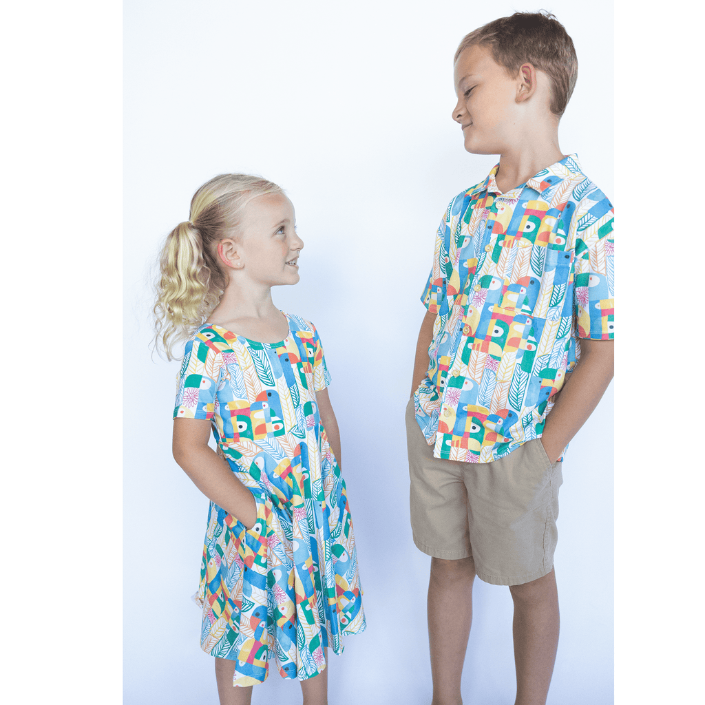 Anise & Ava exclusive hand drawn genderless Parrots print, eco friendly printed on luxury stretch cotton into our new button down collar vacation shirt. Designed and made to match siblings styles in Journey girls dresses & our best selling baby Wren body onesie. Dress your family in this happy exclusive print made for all boys & girls. 