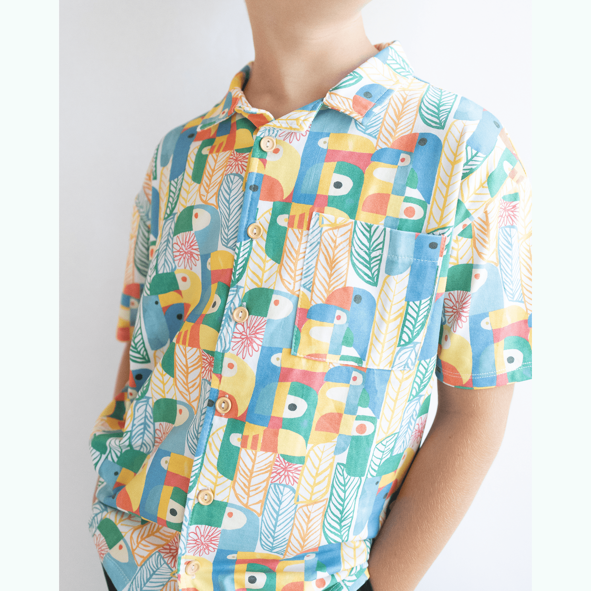 Anise & Ava exclusive hand drawn genderless Parrots print, eco friendly printed on luxury stretch cotton into our new button down collar vacation shirt. Designed and made to match siblings styles in Journey girls dresses & our best selling baby Wren body onesie. Dress your family in this happy exclusive print made for all boys & girls. 