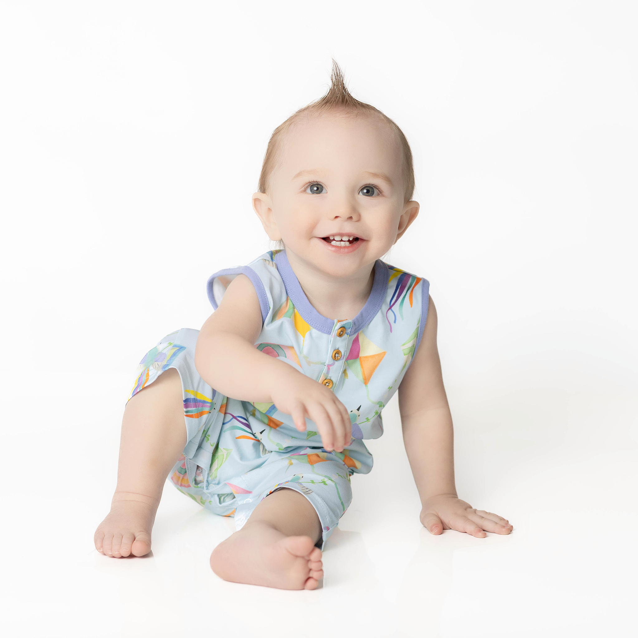 Cleo baby romper in an exclusive hand drawn art, flying kites, by Anise & Ava.