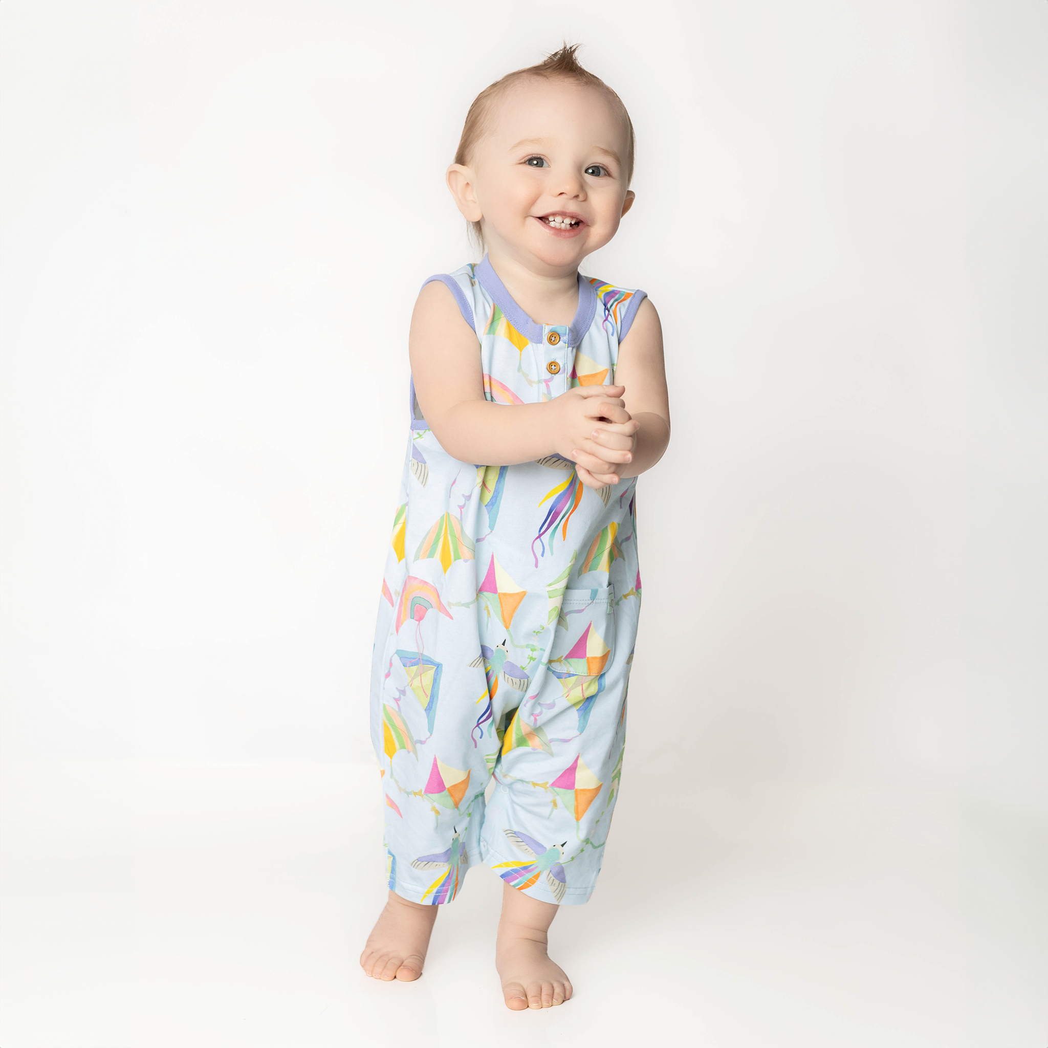 Cleo baby romper in an exclusive hand drawn art, flying kites, by Anise & Ava.