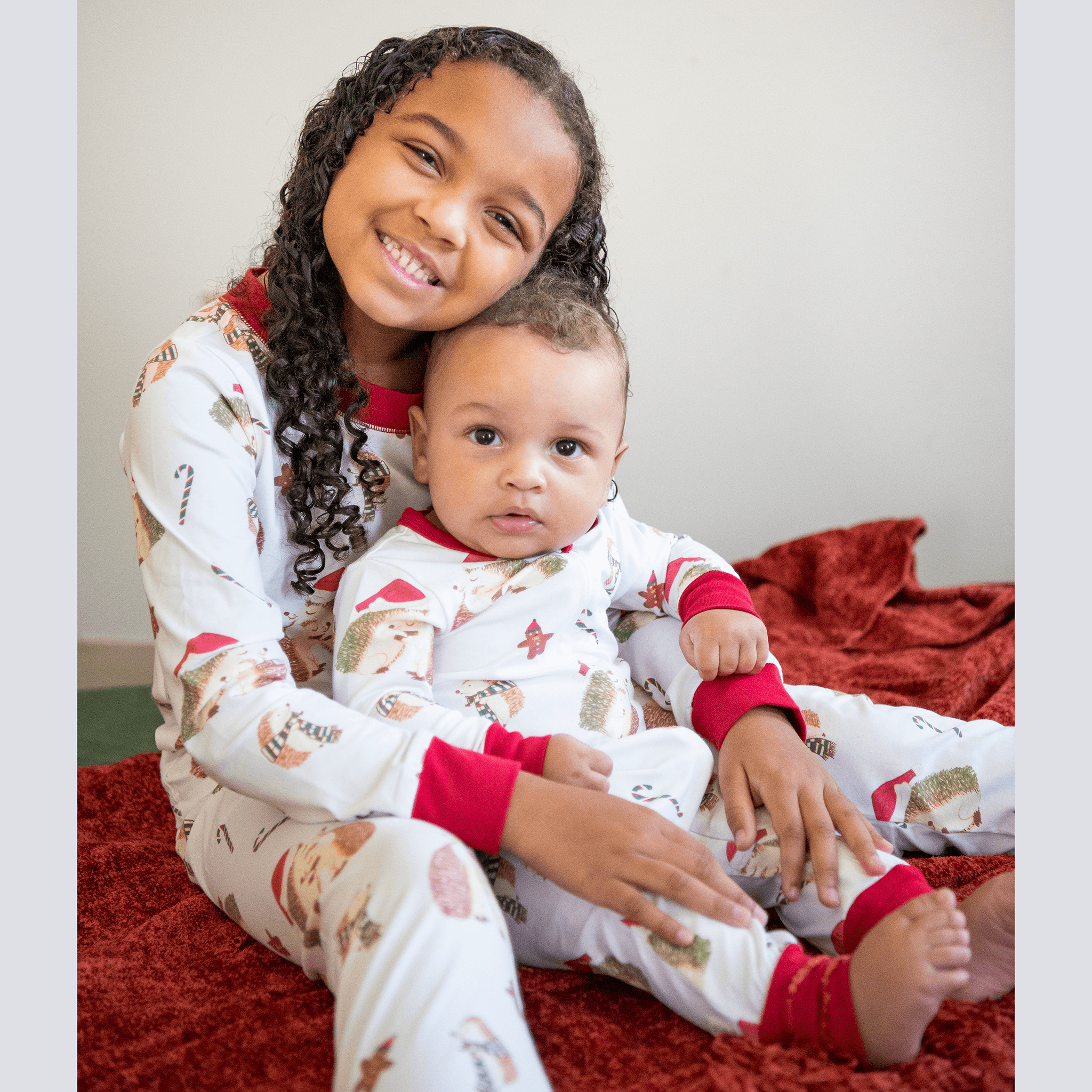 Anise & Ava's gender neutral exclusive hand drawn art in hedgehogs with Holiday hats,, eco friendly printed onto the softest cotton. Made to match siblings' 2 pieces pajamas sets. 