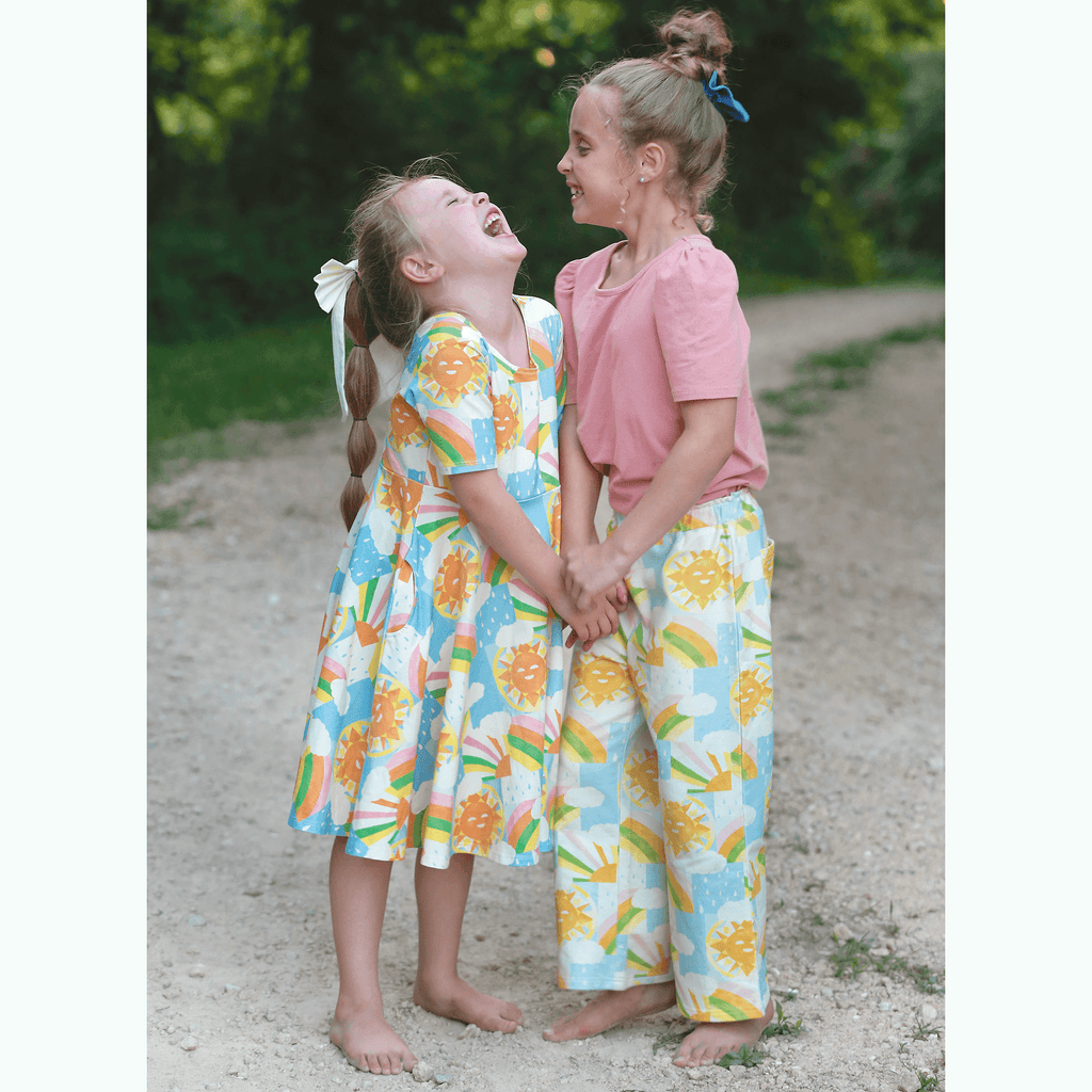 Anise & Ava exclusive hand drawn Sun print eco friendly printed on luxury stretch cotton. Designed and made to match siblings styles. Short sleeves Journey dress is Anise & Ava best selling style, made with deep pockets to hold all the treasures. Siblings matching styles are Brooklyn tee & Charlie baby dress. 