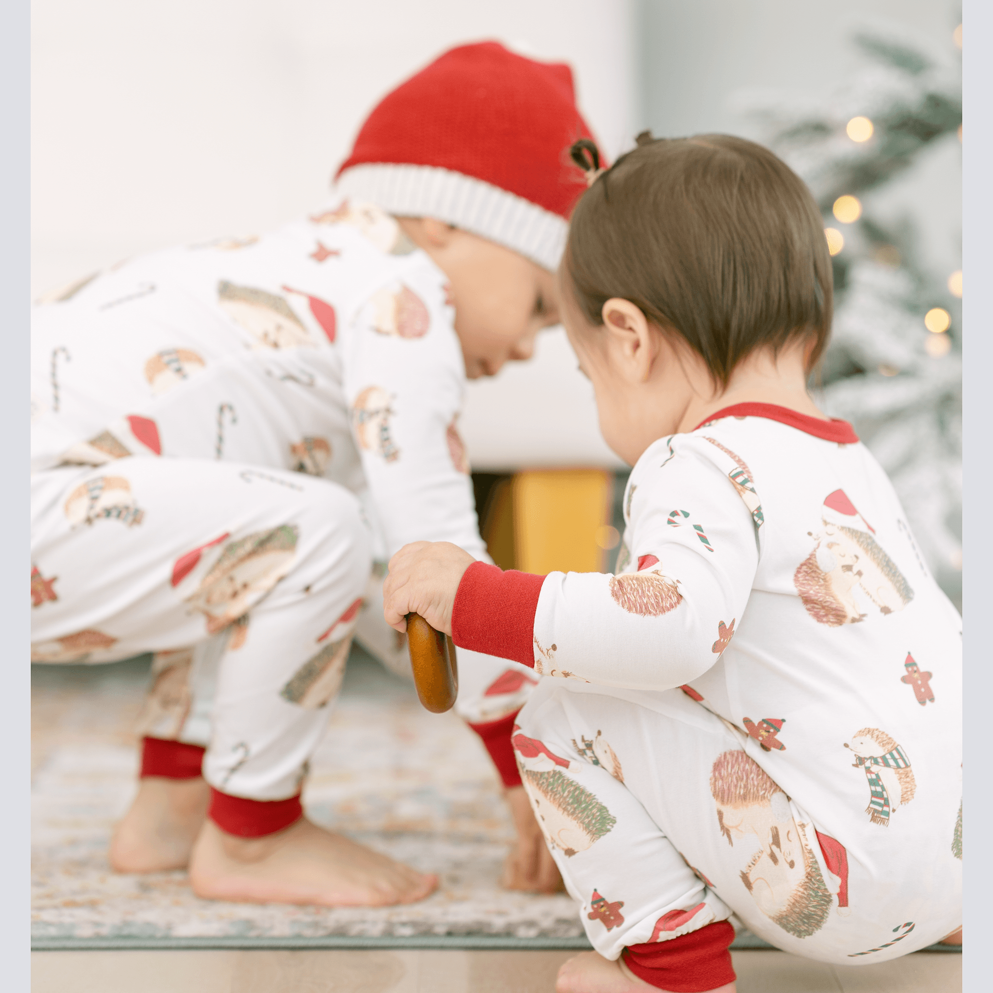 Anise & Ava's gender neutral exclusive hand drawn art in hedgehogs with Holiday hats,, eco friendly printed onto the softest cotton. Made to match siblings' 2 pieces pajamas sets. 