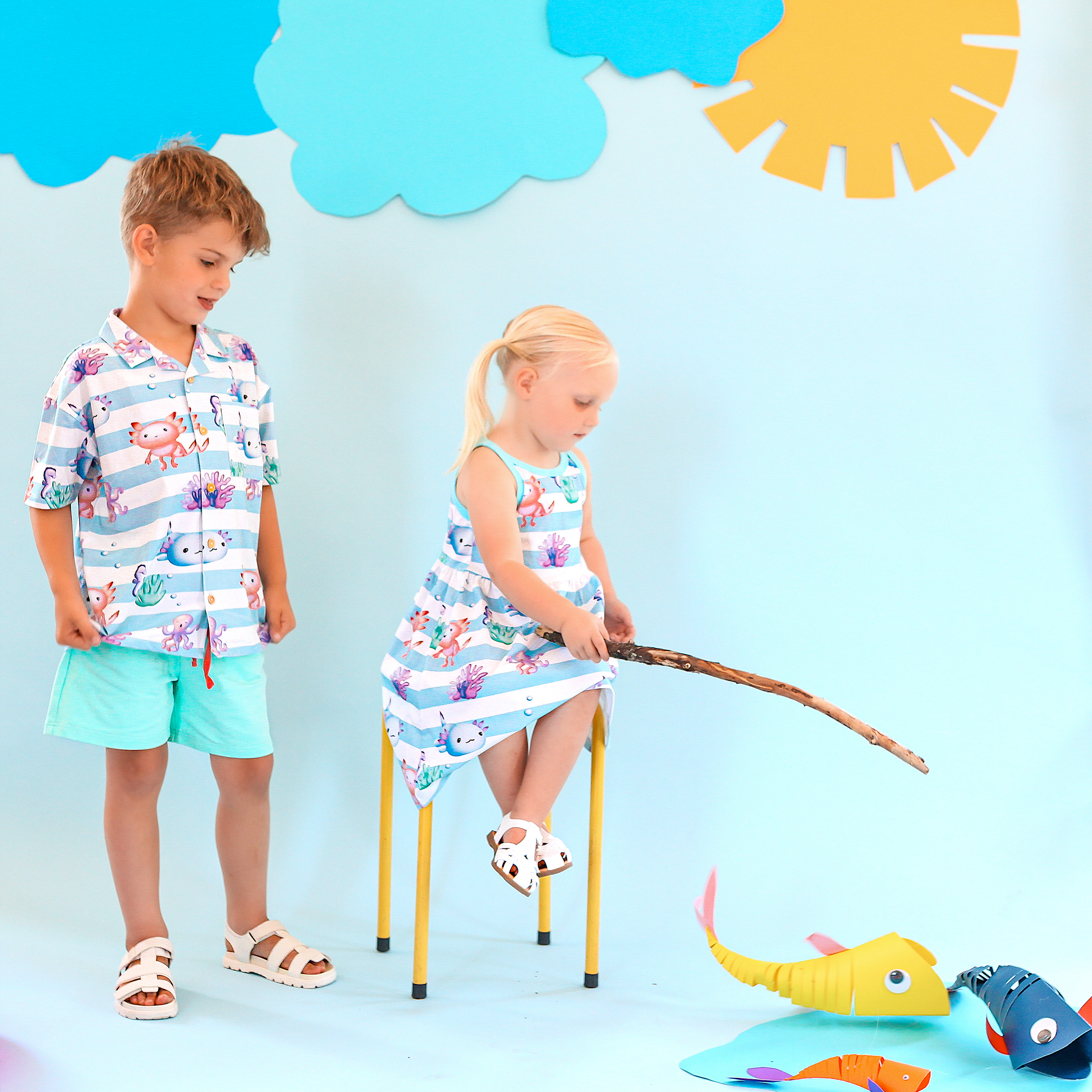 Anise & Ava's Cory button down shirt, designed and made in one of a kind, exclusive hand drawn gender neutral colorful art, featuring a special axolyt. Created to match with other siblings' styles. 