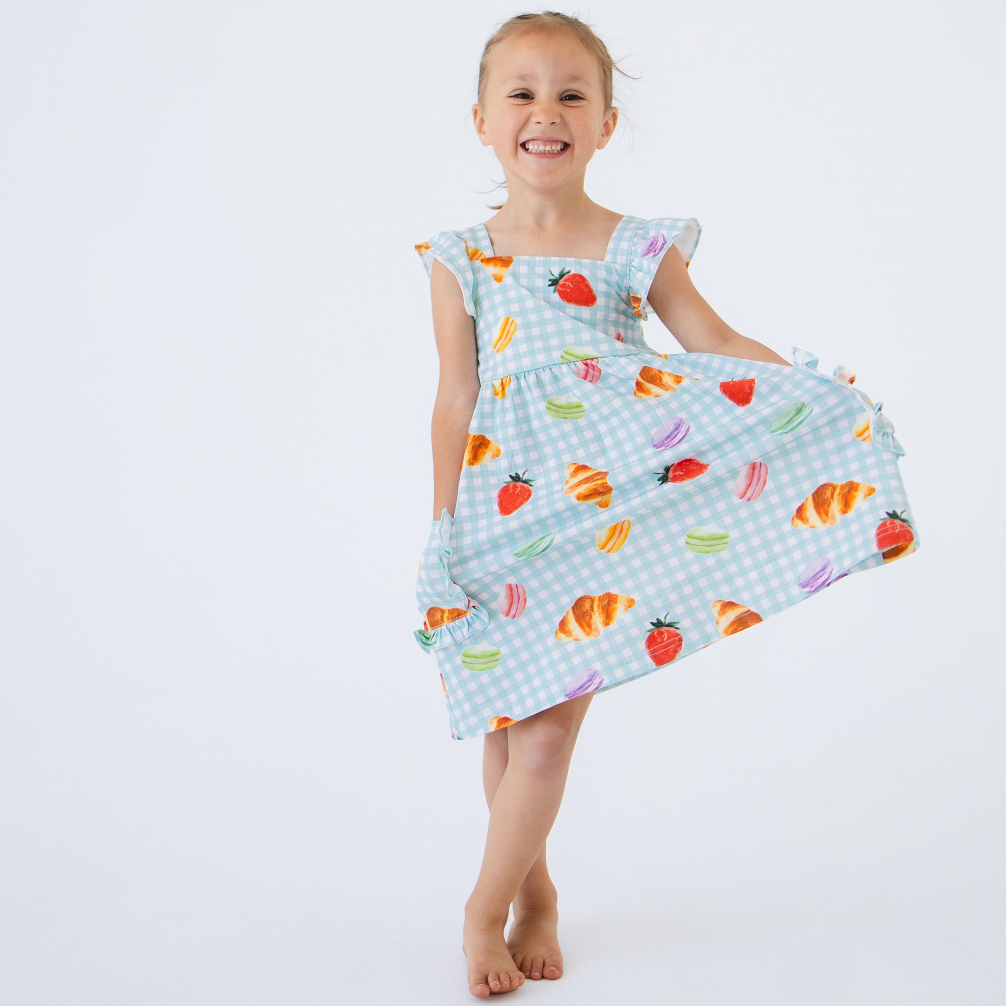 Anise & Ava's Ashley dress with rufles, best seller updated with ruffled pockets, in Picnic Time print, designed and made to match siblings' styles. 
