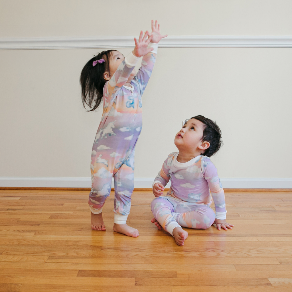 Anise & Ava long sleeves baby zippy onesie. Designed and made with exclusive hand drawn matching ombre dreamy prints to match kids' pajamas. 