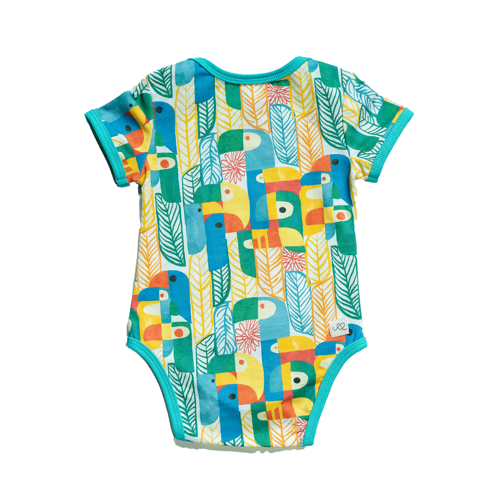Anise & Ava's gender neutral colorful exclusive artwork designed and drawn in house. Baby snap body in Parrots print made to match siblings' styles in dresses & shirts for all boys & girls. 