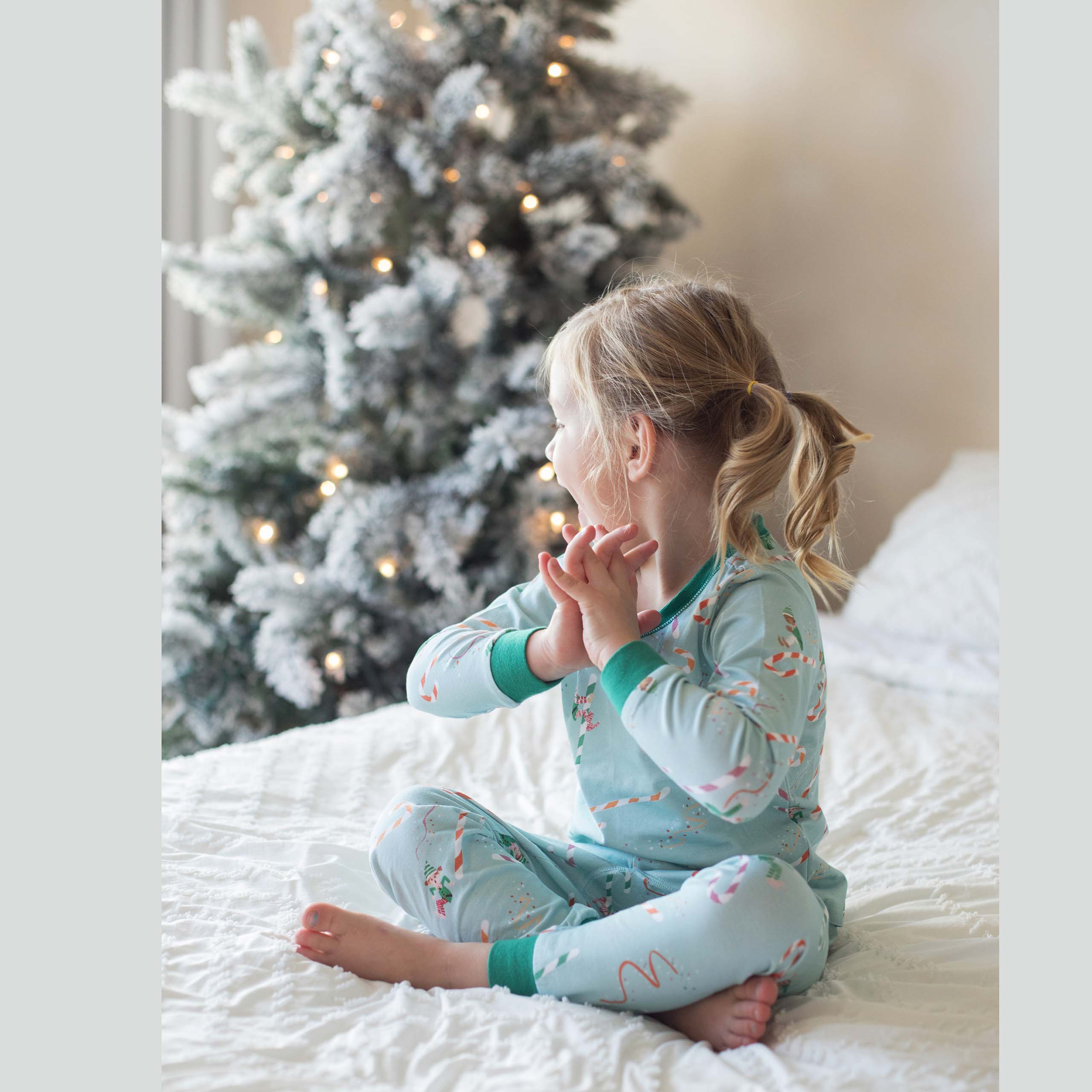 Anise & Ava 2 pcs holiday pajamas made to twin with baby's zip onsie. Created and drawn in house with an exclusive original genderless artwork you won't find anywhere else. Jam up with all the elvies of different skin color and ethnicities sliding down  candy cane slides!!!