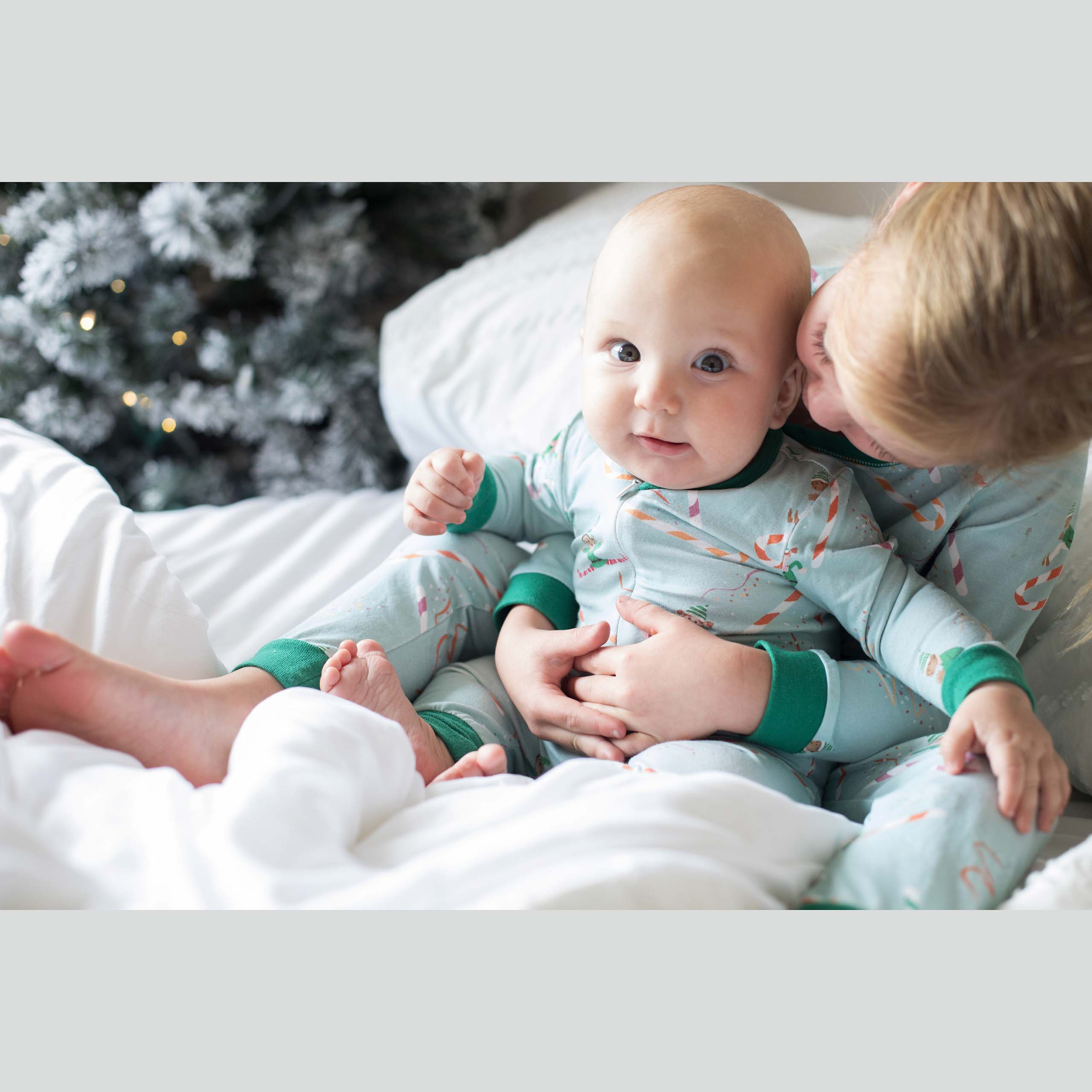 Anise & Ava 2 pcs holiday pajamas made to twin with baby's zip onsie. Created and drawn in house with an exclusive original genderless artwork you won't find anywhere else. Jam up with all the elvies of different skin color and ethnicities sliding down  candy cane slides!!!