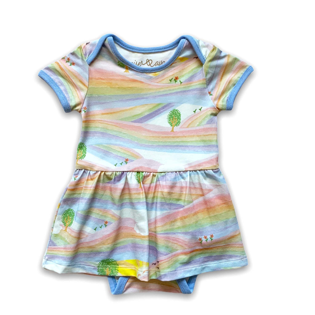 Anise & Ava baby onesie dress front in genderless Sunray Rainbow print front with contrast ribbing and envelop neck for easy wearing. 