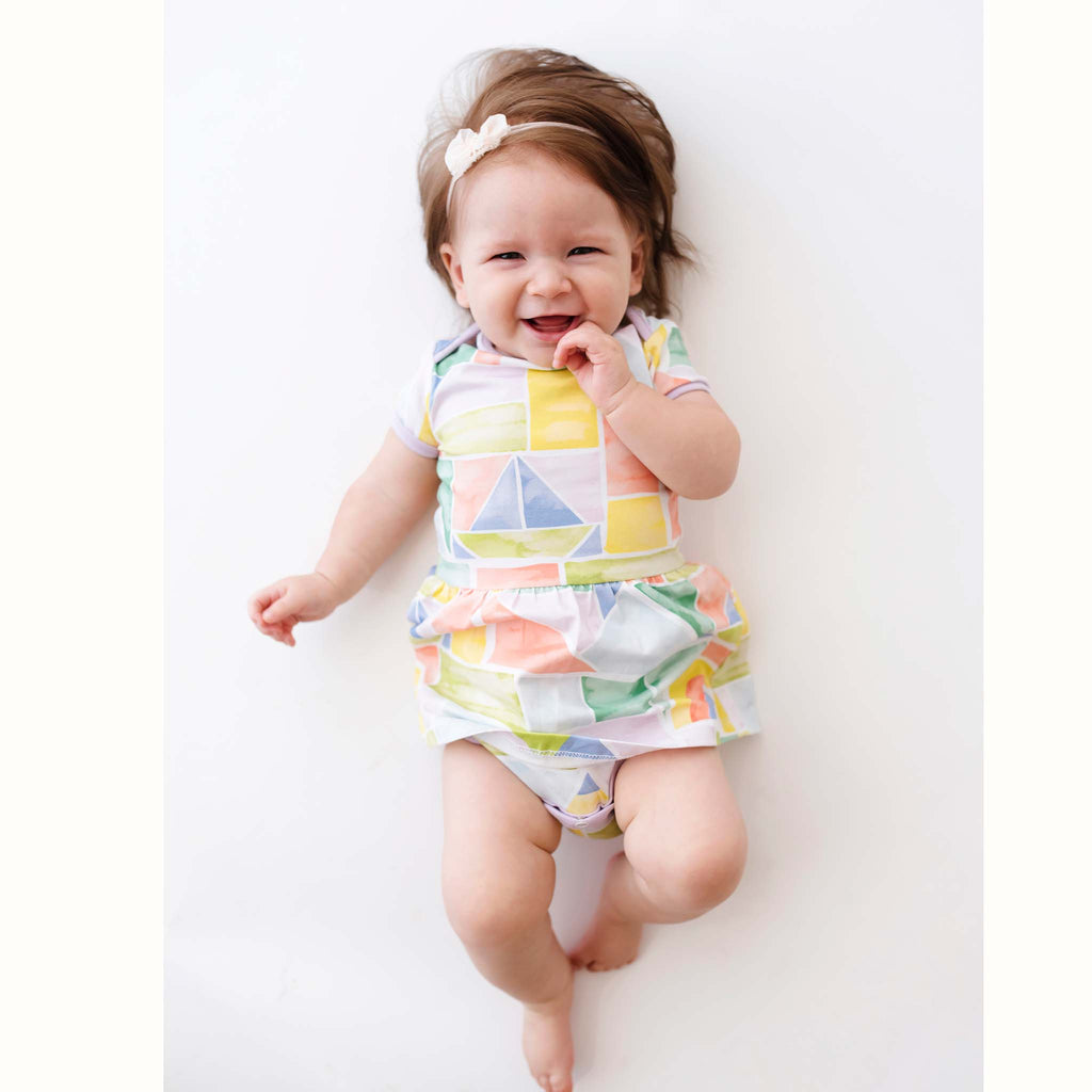 Anise & Ava baby girl onesie dress in gender neutral hand drawn exclusive art eco friendly printed on luxury cotton, in Rainbow Blocks print, made to match with siblings' styles. 