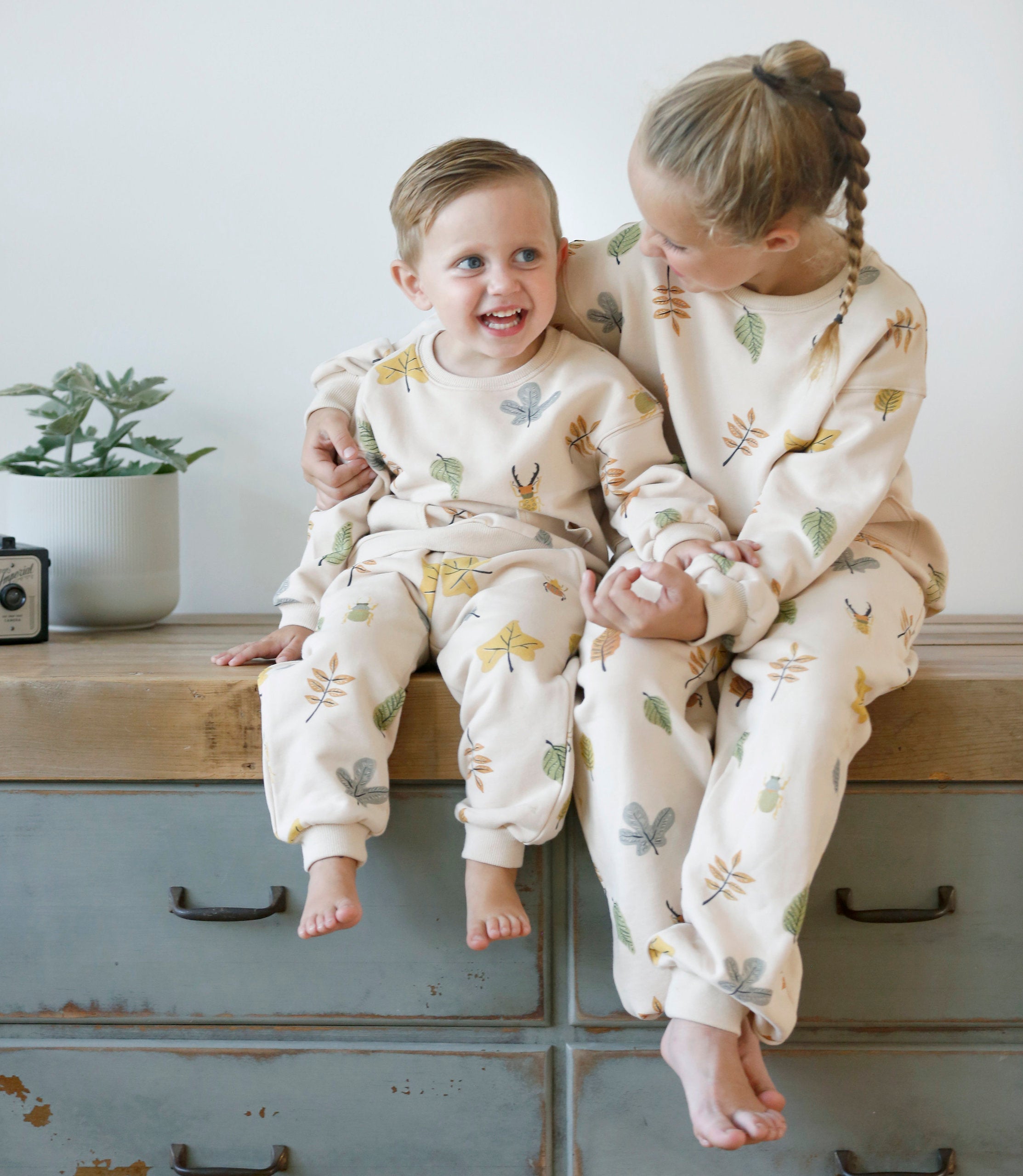 Anise & Ava gender fluid colorful hand drawn prints eco friendly printed onto Cotton terry sweatshirt. Sweatshirt has front ribbed pockets dyed to match  to ground color. Made to match with siblings. 