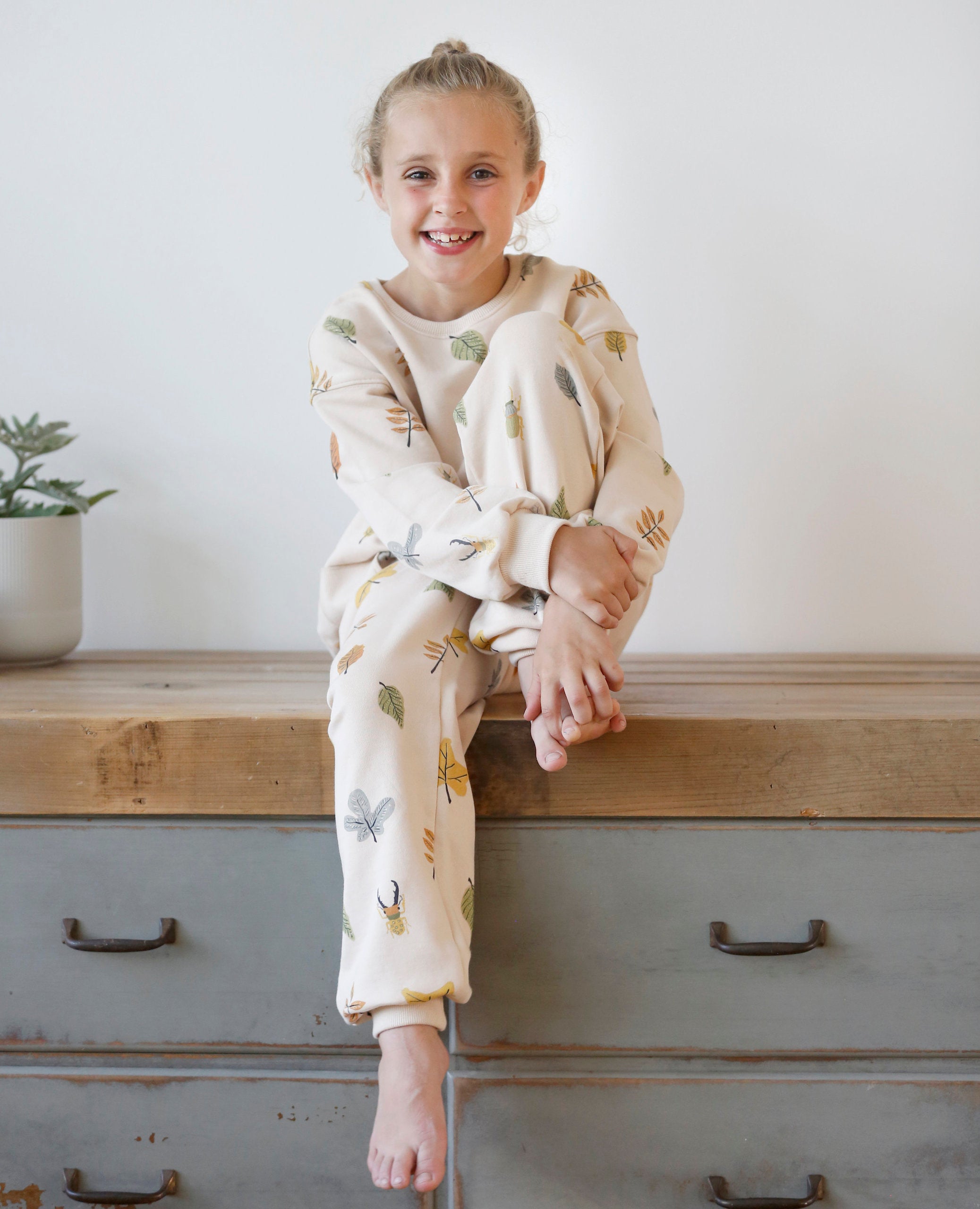 Anise & Ava gender fluid colorful hand drawn prints eco friendly printed onto Cotton terry sweatshirt. Sweatshirt has front ribbed pockets dyed to match  to ground color. Made to match with siblings. 