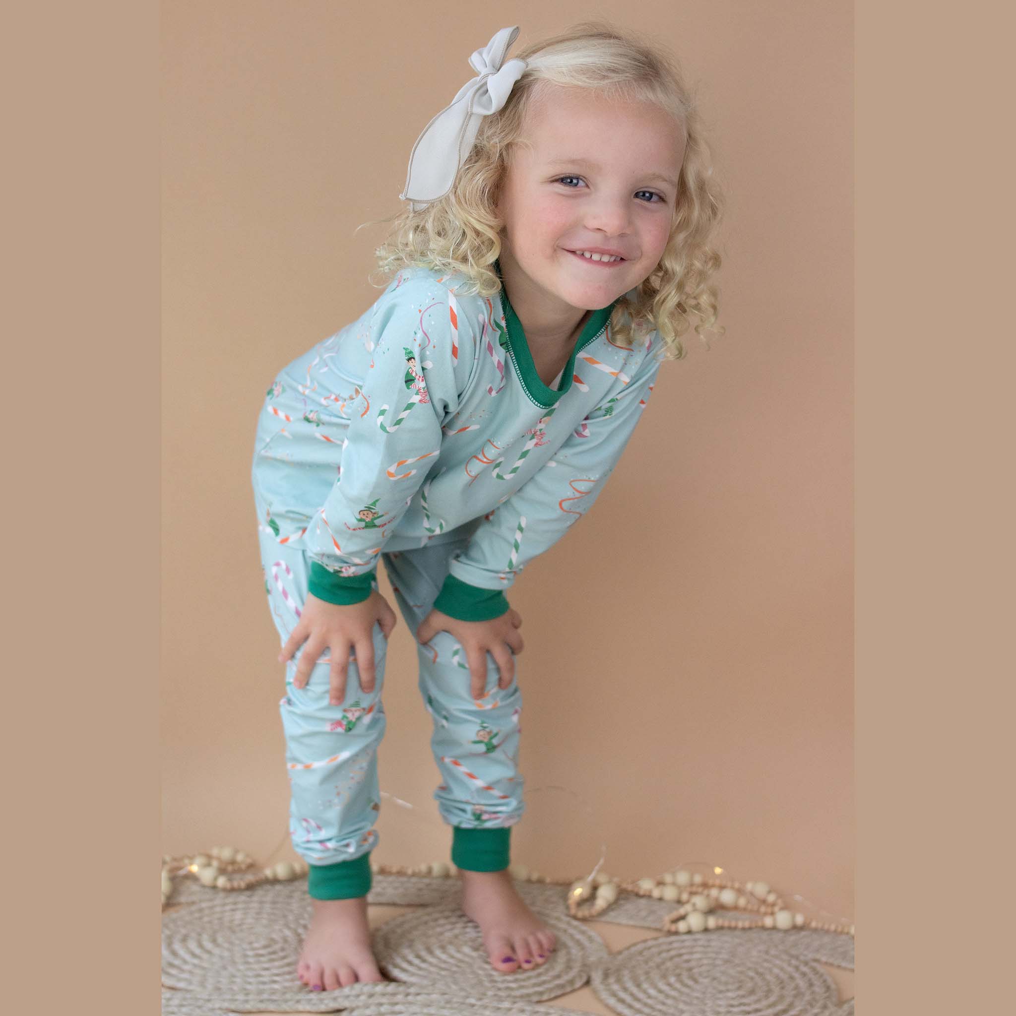 Anise & Ava 2 pcs holiday pajamas made to twin with baby's zip onsie. Created and drawn in house with an exclusive original genderless artwork you won't find anywhere else. Jam up with all the elvies of different skin color and ethnicities sliding down  candy cane slides!!!