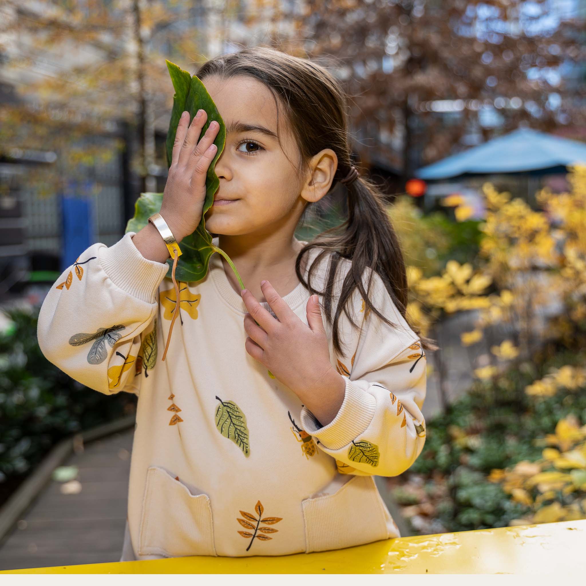 Anise & Ava gender fluid colorful hand drawn prints eco friendly printed onto Cotton terry sweatshirt. Sweatshirt has front ribbed pockets dyed to match  to ground color. Made to match with siblings. 